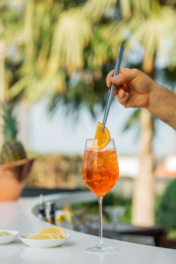Mondrian Doha Hotel Exterior photo A spritz being garnished with an orange slice